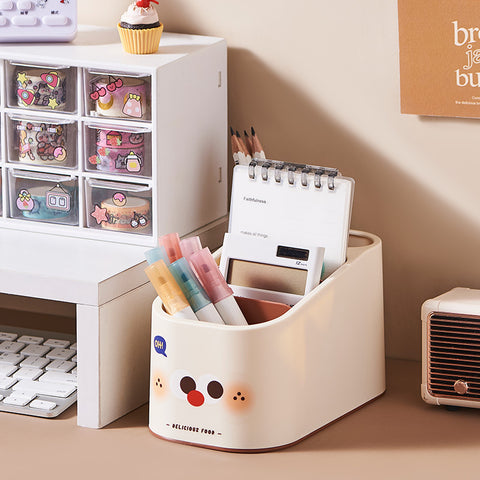 Desk organizer with stationery items next to a white storage unit with transparent drawers.