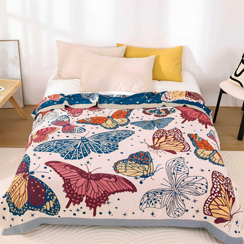 Butterfly cotton summer throw blanket displayed on a bed, featuring colorful jacquard design for year-round use.