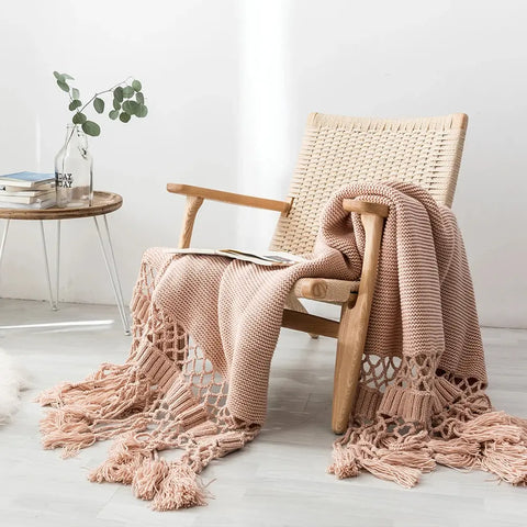 Dusty Rose Handmade Nordic Knit Tassel Blanket draped over wooden chair – luxury sofa throw
