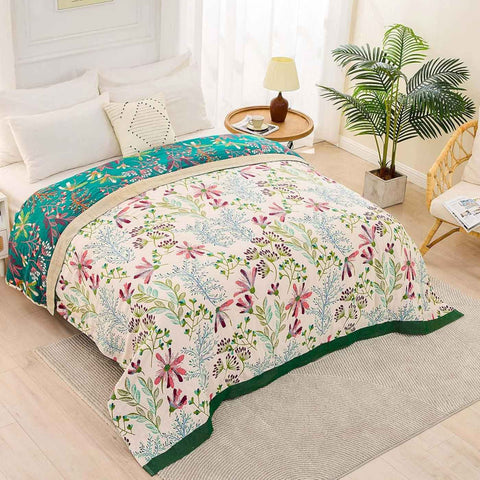 Floral Serenity cotton quilt blanket with reversible design spread on a bed in a bright bedroom with modern decor and natural light.
