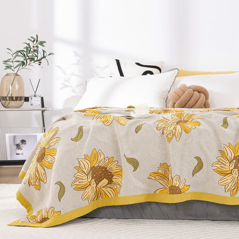 Light yellow floral quilt neatly draped over bed