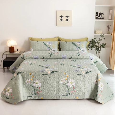 Green botanical quilted bedding set with floral pillowcases and soft cotton texture