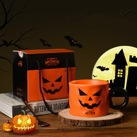 Halloween-themed mug and gift bag with pumpkins and bats on a dark background