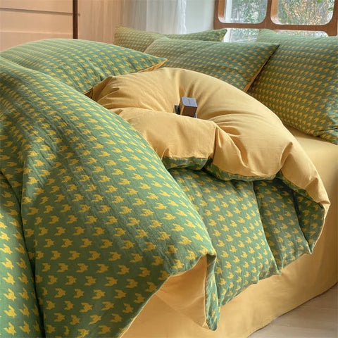 Close-up of Milano houndstooth green and yellow cotton bedding set with soft duvet cover and matching pillows