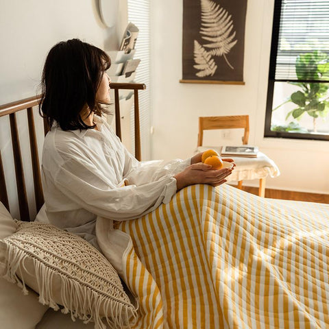 Yellow striped cotton summer quilt with breakfast tray