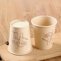 Reusable bamboo fiber cup set on rustic wood
