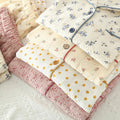 Floral and polka dot quilted fabric pieces on a light background