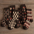 A collection of Yuki Retro Wool Socks with various patterns including checkered and floral, displayed on a wooden surface.