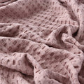Lightweight pink summer blanket in minimalist bedroom