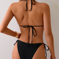 Back view of black tie-up bikini set with gold bead details on straps