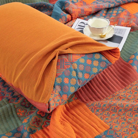 Colorful quilt with a cup and saucer on a patterned fabric background