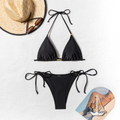 Black bikini set with gold bead accents – flat lay with sunglasses and seashells