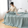Lightweight pink summer blanket in minimalist bedroom