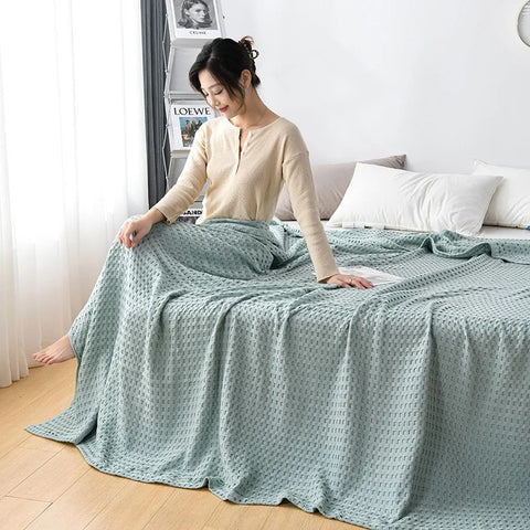 Lightweight pink summer blanket in minimalist bedroom