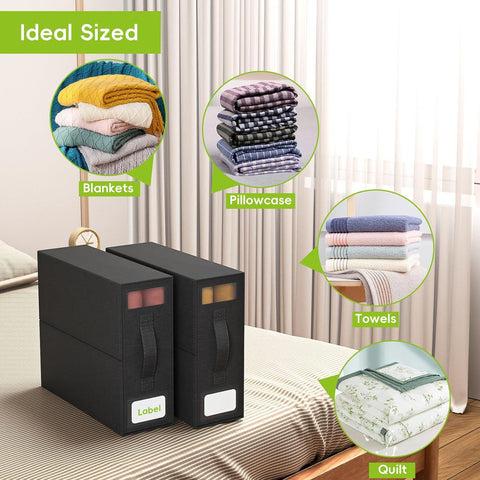 Black storage boxes with labeled sections for blankets, pillowcases, towels, and quilts on a bed.