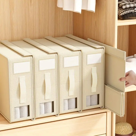 Set of beige storage boxes with clear panels and handles on a wooden shelf.