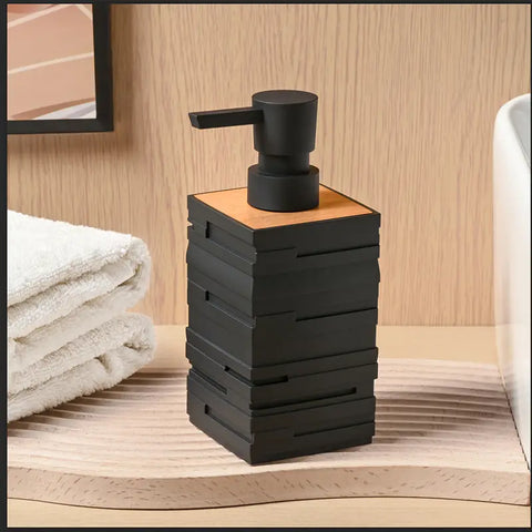 Black soap dispenser with wooden top on a bathroom counter