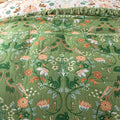 Close-up of a green fabric with floral and animal pattern