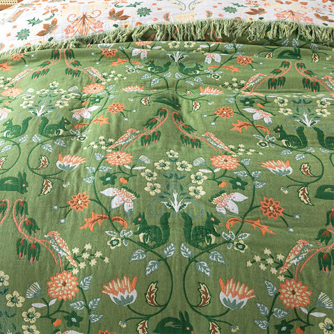 Close-up of a green fabric with floral and animal pattern