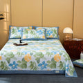 Floral patterned bedspread on a bed with matching pillows in a bedroom setting.