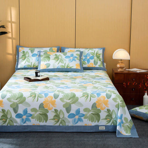Floral patterned bedspread on a bed with matching pillows in a bedroom setting.