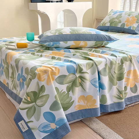 Floral patterned bedspread on a bed with pillows in a bedroom setting.