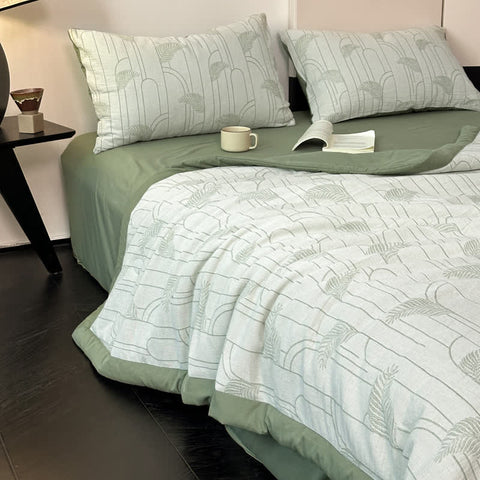 Summer cotton bedding in sage green with matching pillows and dark flooring