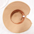 Woman wearing khaki straw sun hat with bow detail