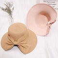Lightweight straw hat with large bow in milky white color
