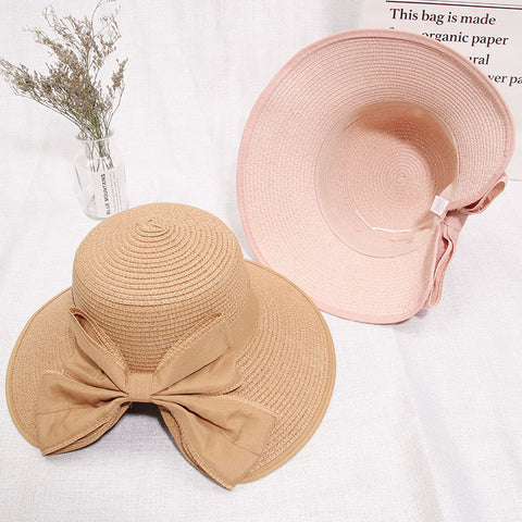 Lightweight straw hat with large bow in milky white color