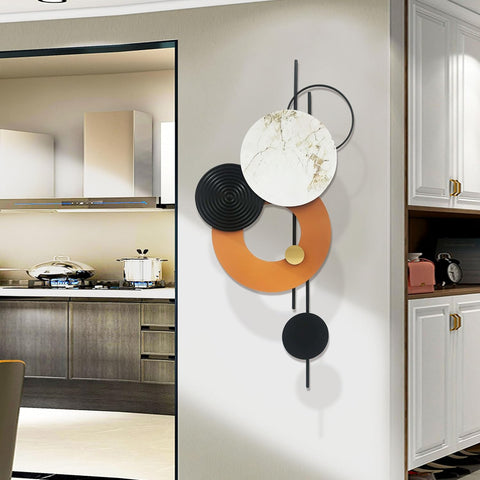 Decorative wall art with circular shapes on a kitchen wall