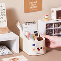Desk organizer with stationery items on a desk, featuring a hand reaching in.