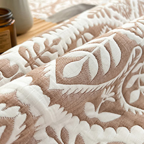 Folded geometric leaf quilt showing soft texture and botanical pattern detail