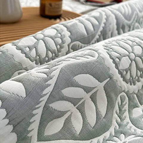 Geometric leaf pattern texture close up showing jacquard weave detail on quilt