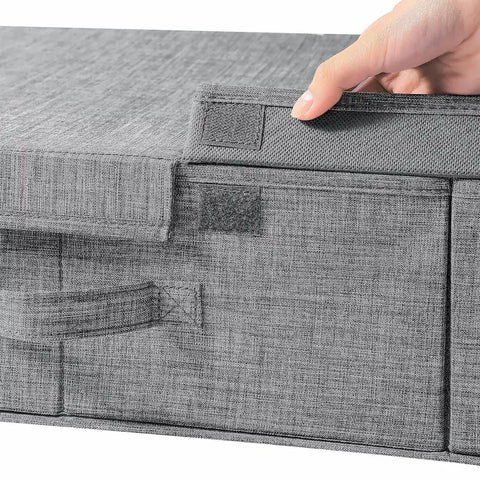 Gray fabric storage box with a hand lifting the lid