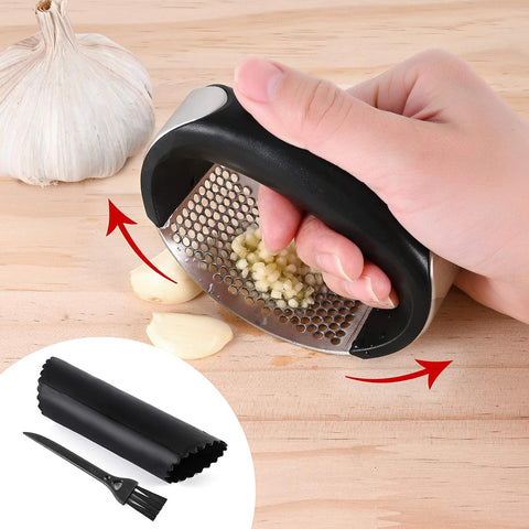 Hand using a garlic press on garlic cloves with a close-up of the press and additional parts on a wooden surface.