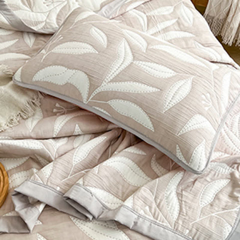 Patterned pillow and blanket set on a bed