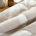 Close-up of a textured white fabric surface with stitching details.
