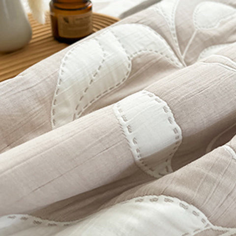 Close-up of a textured white fabric surface with stitching details.