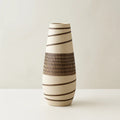 Ceramic vase with brown stripes on a light background