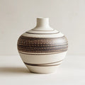 Ceramic vase with brown patterns on a light background