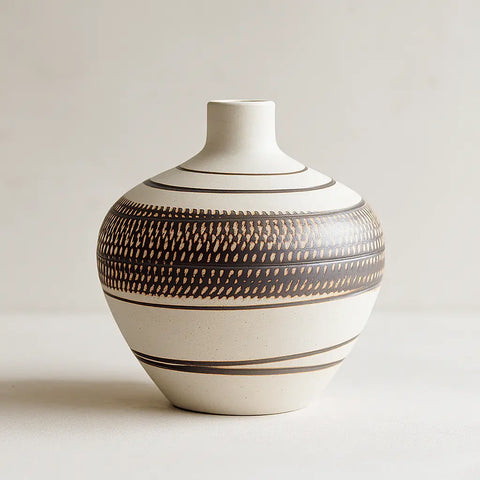 Ceramic vase with brown patterns on a light background