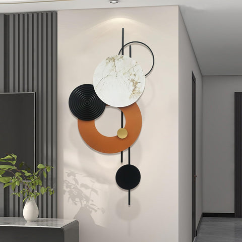 Modern wall art with geometric shapes on a neutral wall.