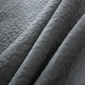 Close-up of a textured gray quilted fabric
