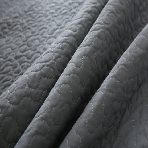 Close-up of a textured gray quilted fabric