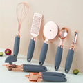 Set of kitchen utensils with rose gold accents on a light background