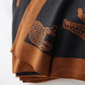 Brown and black patterned fabric with animal designs on a white background