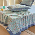 Transform your bedroom into a serene floral sanctuary, where delicate blooms create instant calmThis cotton bedspread showcases tiny ditsy florals in gentle blue and coral shades with sophisticated charcoal edging. The breathable cotton weave works beautifully as a lightweight quilt for summer or versatile coverlet for layering, while the scattered floral motifs bring cottage charm to any space.