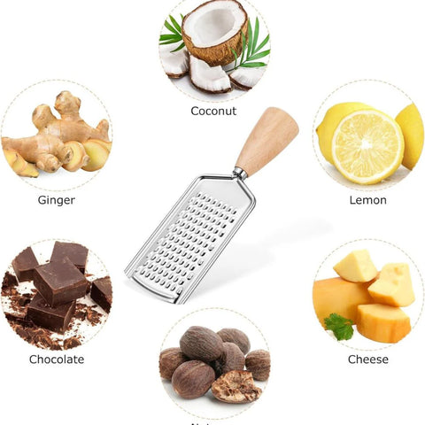 Collection of ingredients including coconut, lemon, ginger, chocolate, cheese, and nuts with a grater in the center.