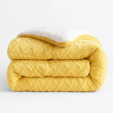 Yellow quilted blanket on a white background